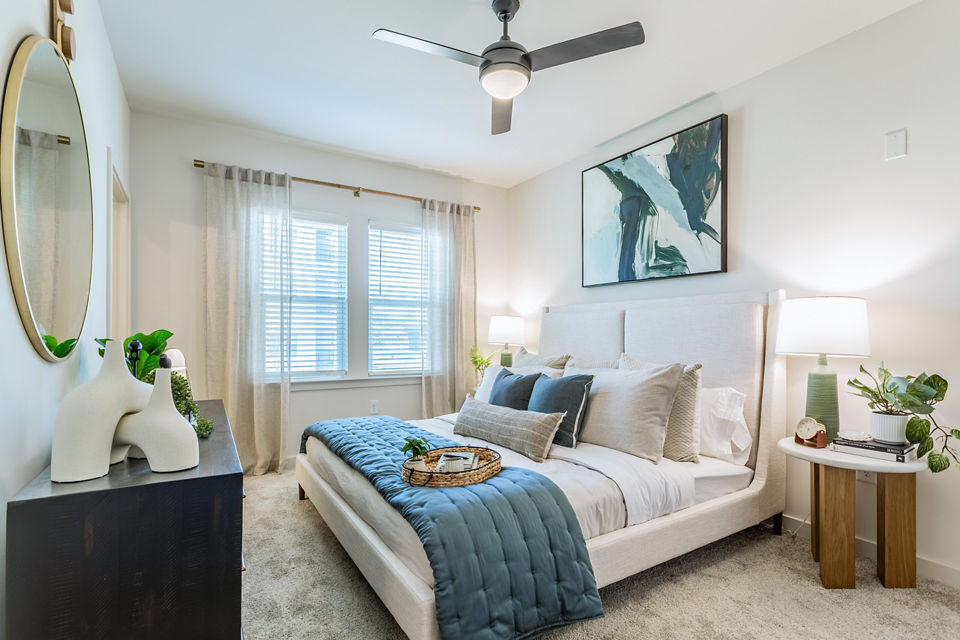 Cozy bedroom with modern furnishings at Birchway Rivergate Apartments