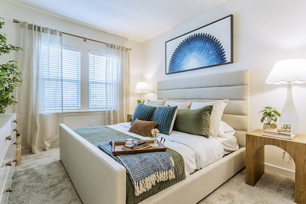 Cozy bedroom with modern decor in Birchway Rivergate Apartments, offering luxury living spaces tailored for comfort