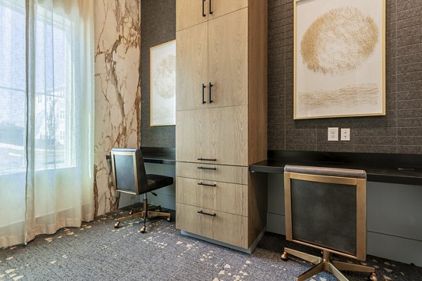 Modern business center with ergonomic furnishings at Birchway Rivergate Apartments, ideal for professionals seeking luxury convenience