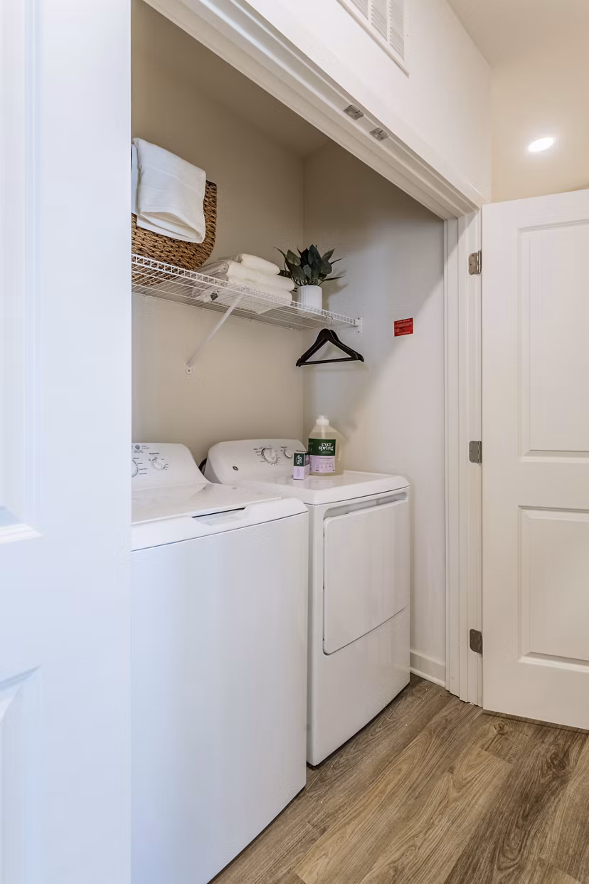 Laundry room with modern appliances at Drexler Townhomes, Birchway Rivergate Apartments