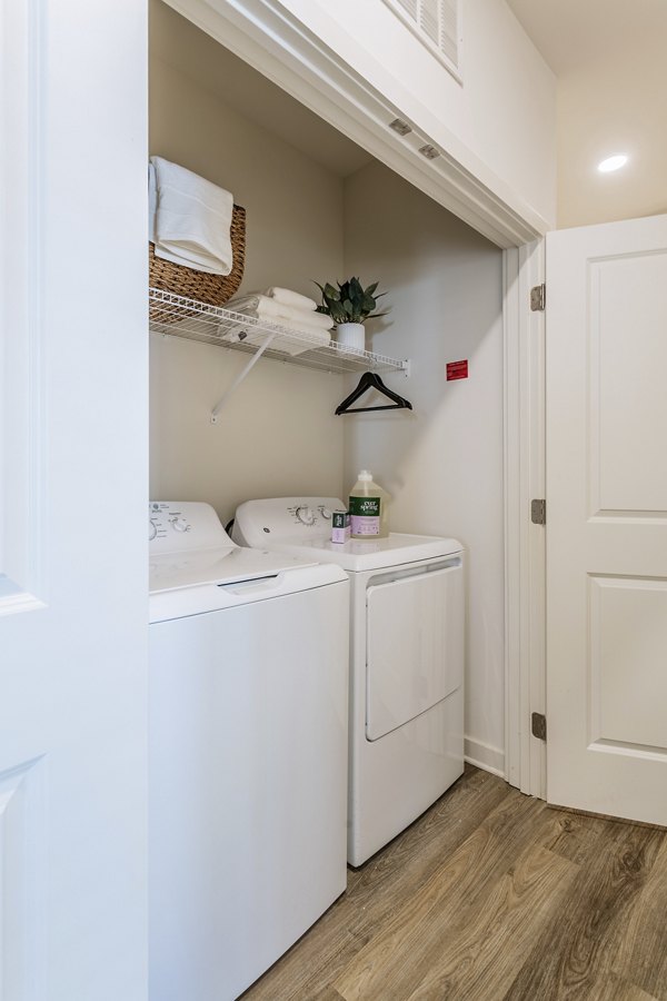 Laundry room with modern appliances at Drexler Townhomes, Birchway Rivergate Apartments