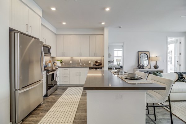 Modern kitchen with stainless steel appliances at Vida at Morgan Hill Apartments