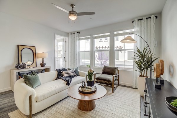 Vida at Morgan Hill Apartments: Modern living room with cozy furnishings and stylish decor