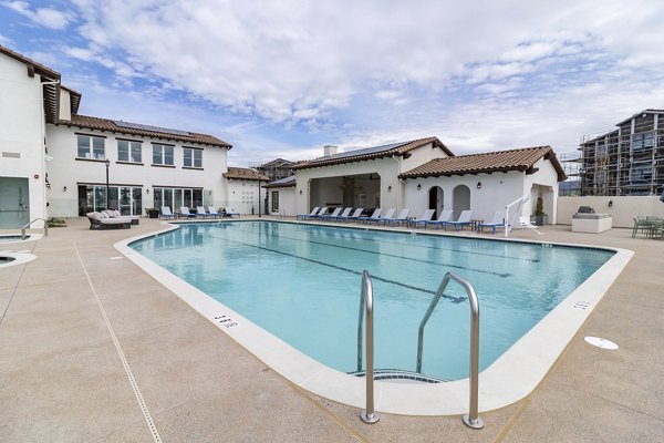 Resort-style pool with loungers at Vida at Morgan Hill Apartments, perfect for relaxation and leisure