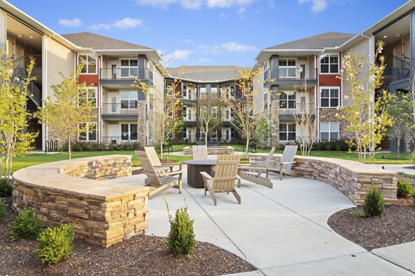 Modern fire pit area at Easton Place Apartments offers outdoor relaxation for residents