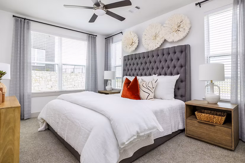 Cozy bedroom with plush bedding and natural light at Avelyn San Marcos luxury apartments