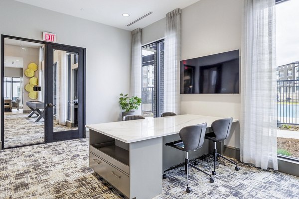 Clubhouse business center with sleek workstations at Avelyn San Marcos Apartments