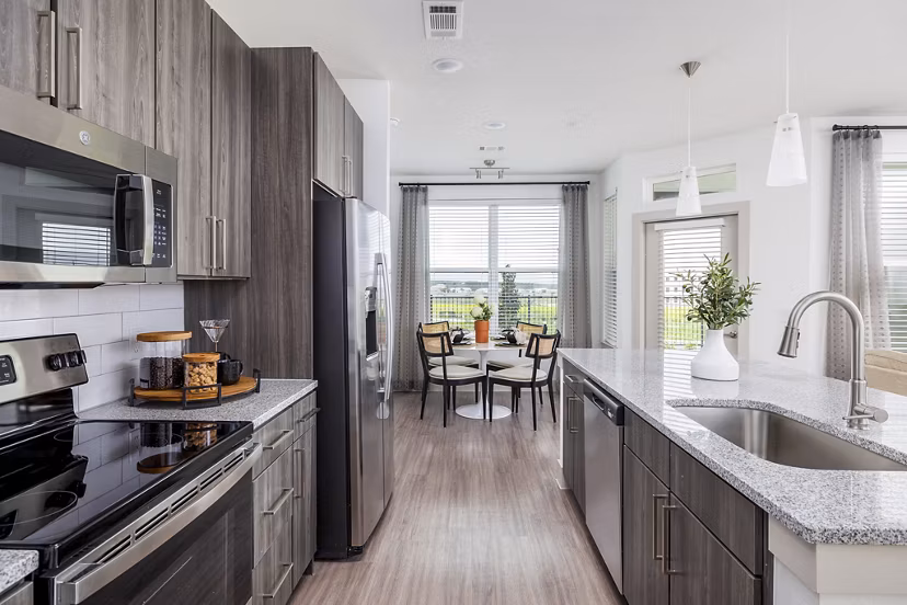 Modern kitchen with stainless steel appliances and sleek countertops at Avelyn San Marcos Apartments