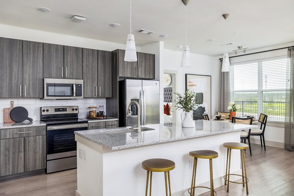 Modern kitchen featuring stainless steel appliances at Avelyn San Marcos Apartments