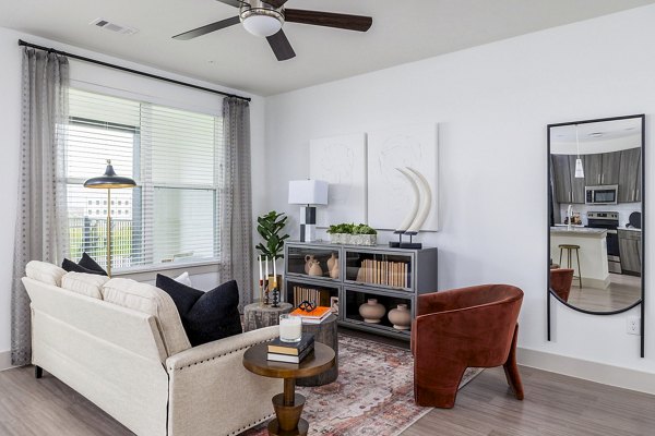 Living room with modern furnishings and large windows at Avelyn San Marcos Apartments, luxury residences in San Marcos