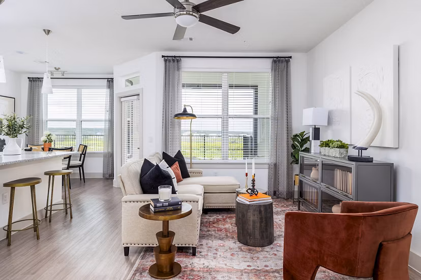 Spacious living room with modern furnishings in Avelyn San Marcos Apartments, featuring comfortable seating and contemporary decor elements