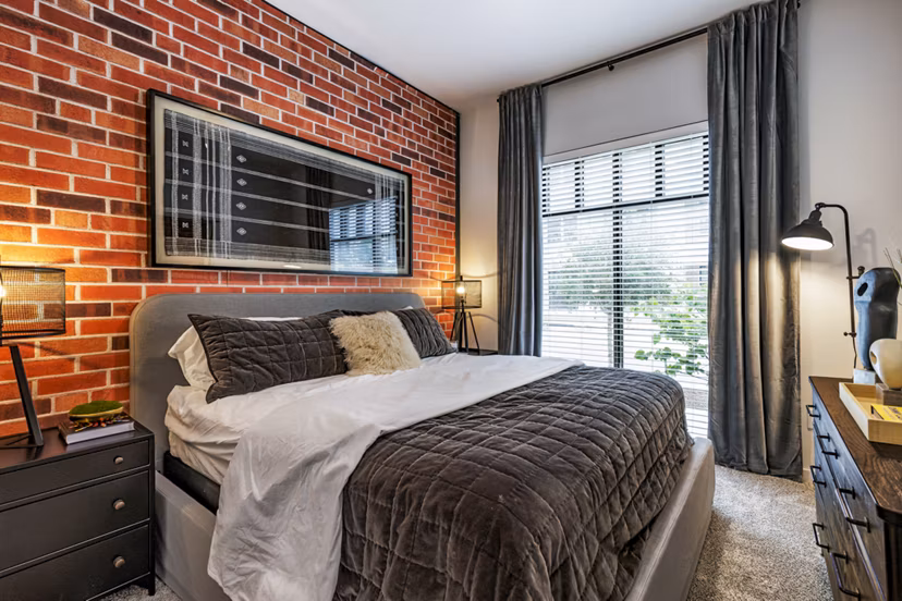 Cozy bedroom with modern decor at Gramercy at Northline Apartments, featuring a neutral color palette and stylish furnishings