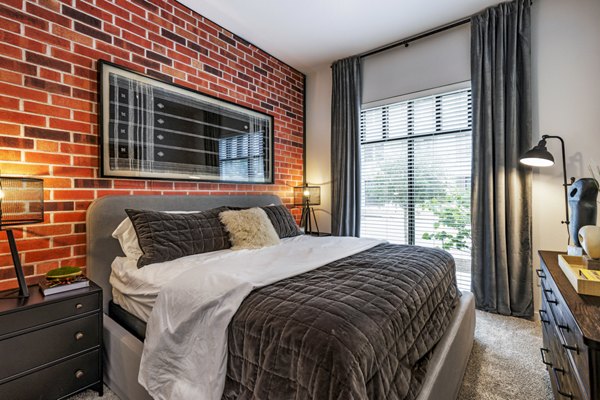 Cozy bedroom with modern decor at Gramercy at Northline Apartments, featuring a neutral color palette and stylish furnishings