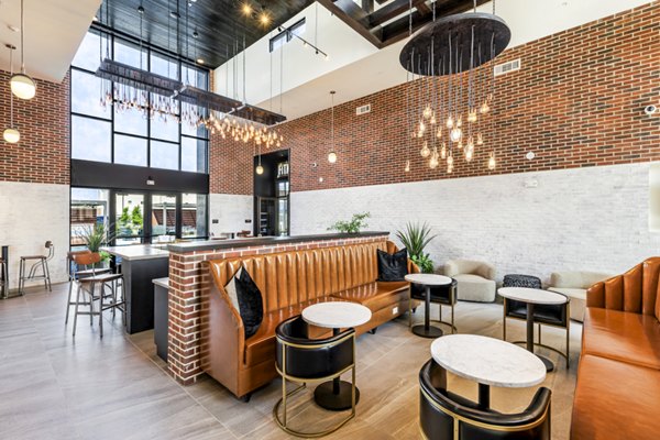 Modern clubhouse with communal seating and games at Gramercy at Northline Apartments