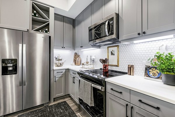 Modern kitchen featuring stainless steel appliances at Gramercy at Northline Apartments