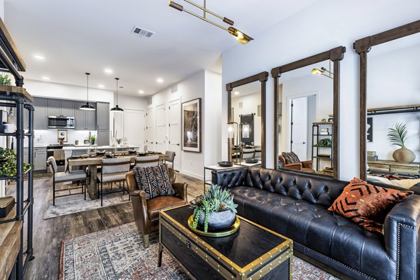 Open-concept living room with stylish decor at Gramercy at Northline Apartments, featuring cozy seating and contemporary furnishings