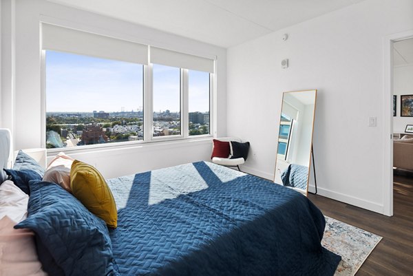 Cozy bedroom with modern decor at Broadridge Apartments, offering luxury living in a prime location