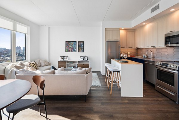 Modern kitchen with marble countertops and stainless steel appliances in Broadridge Apartments