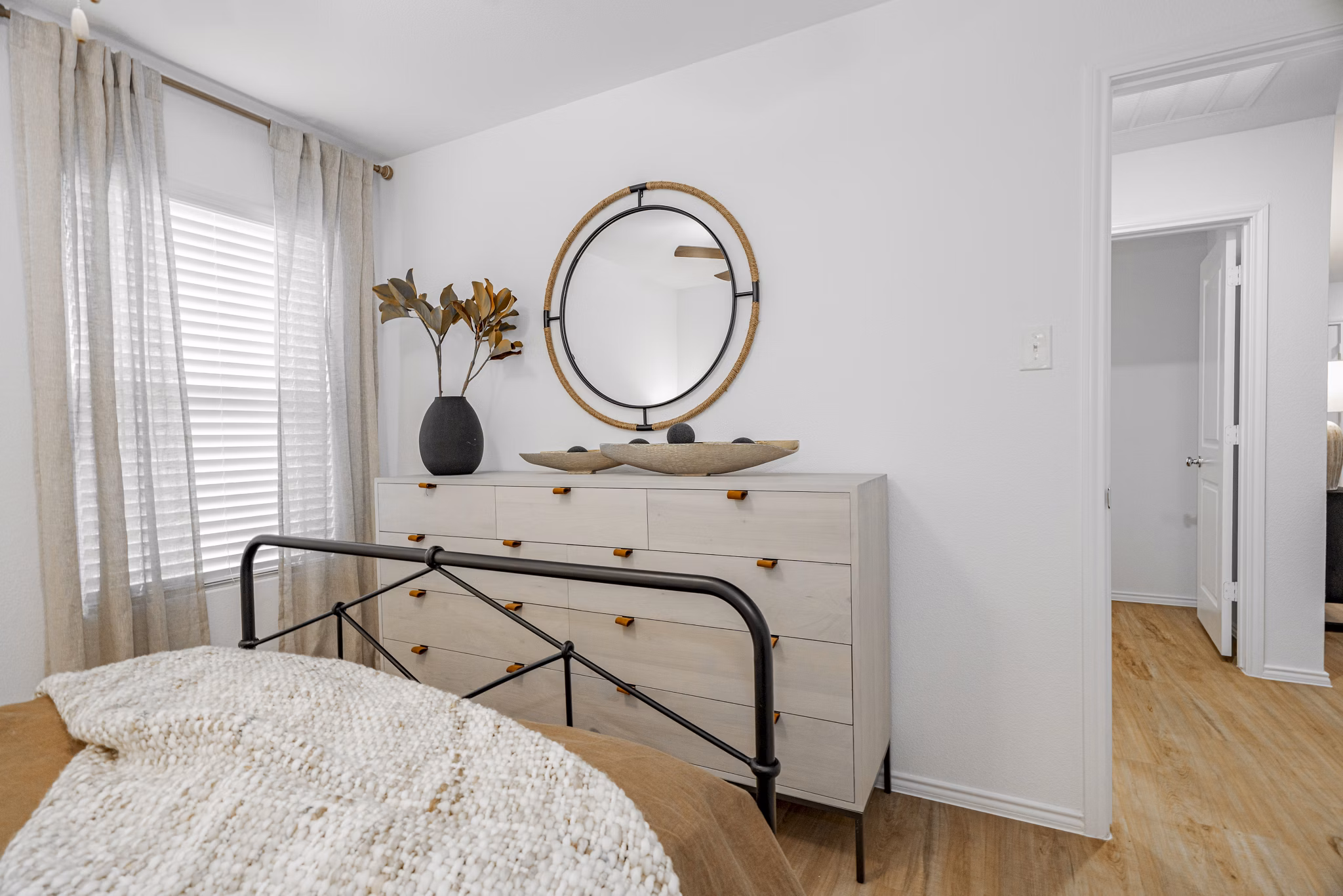 Inviting bedroom featuring cozy decor and large windows at Summerwell Wildcat Ranch luxury apartments