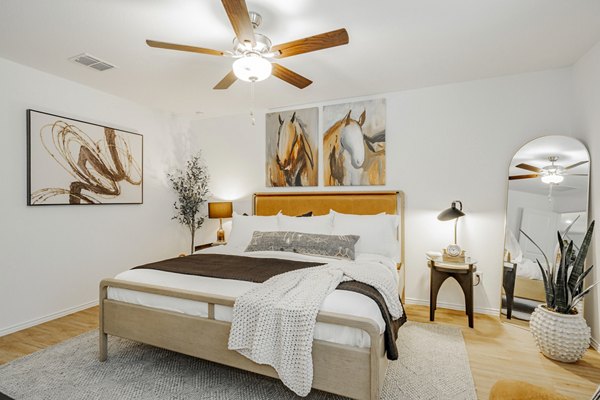 Cozy bedroom with plush bedding at Summerwell Wildcat Ranch Apartments