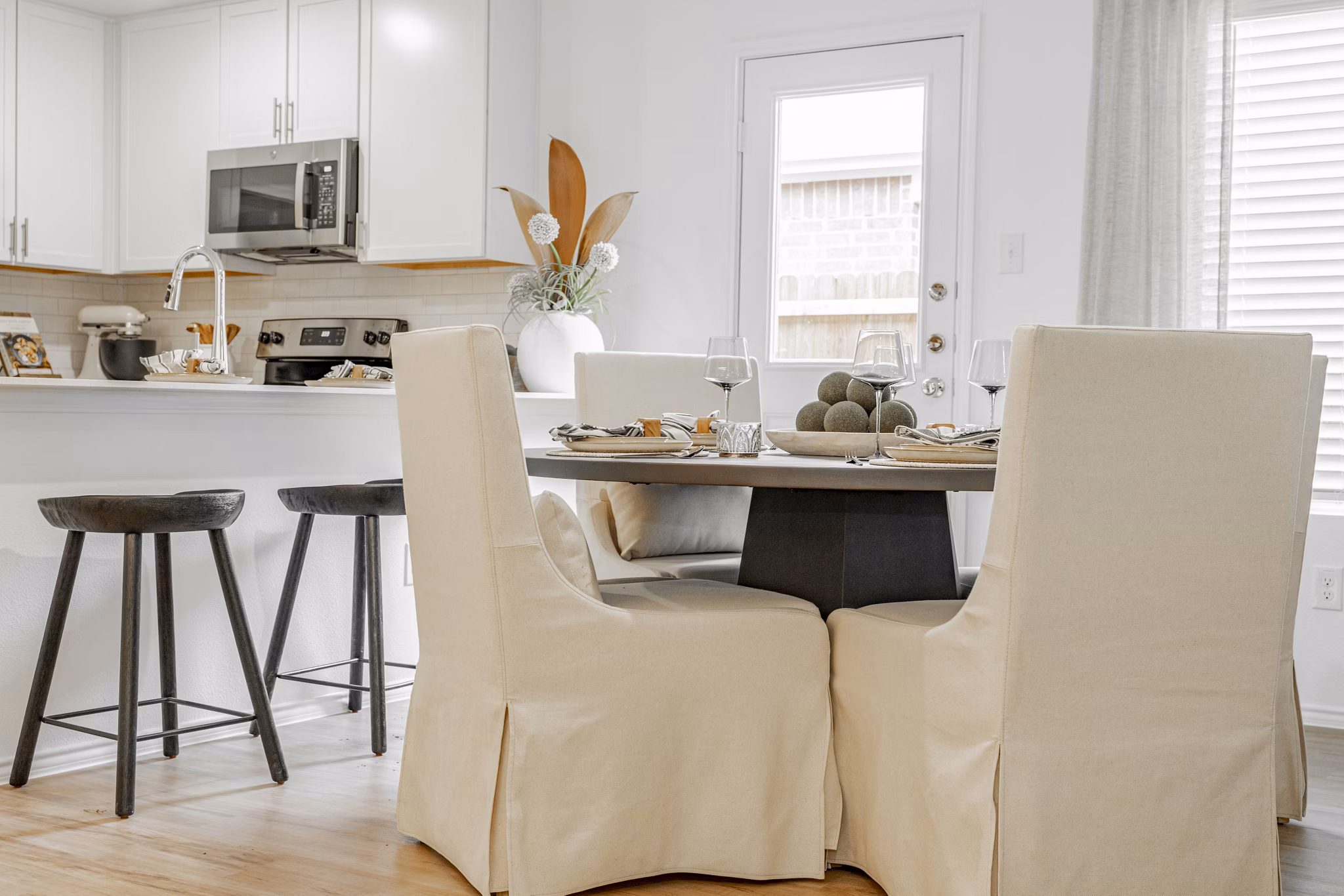 Dining area with elegant furnishings and large windows at Summerwell Wildcat Ranch Home Apartments