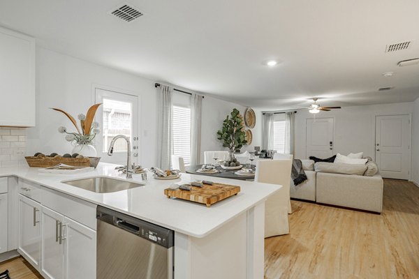 Modern kitchen with stainless steel appliances at Summerwell Wildcat Ranch Home Apartments, offering luxury living