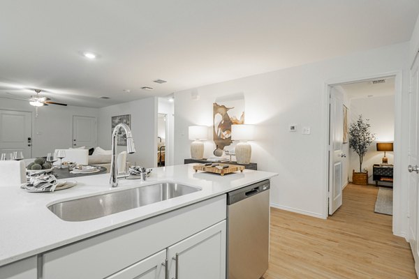 Modern kitchen with stainless steel appliances at Summerwell Wildcat Ranch Home Apartments