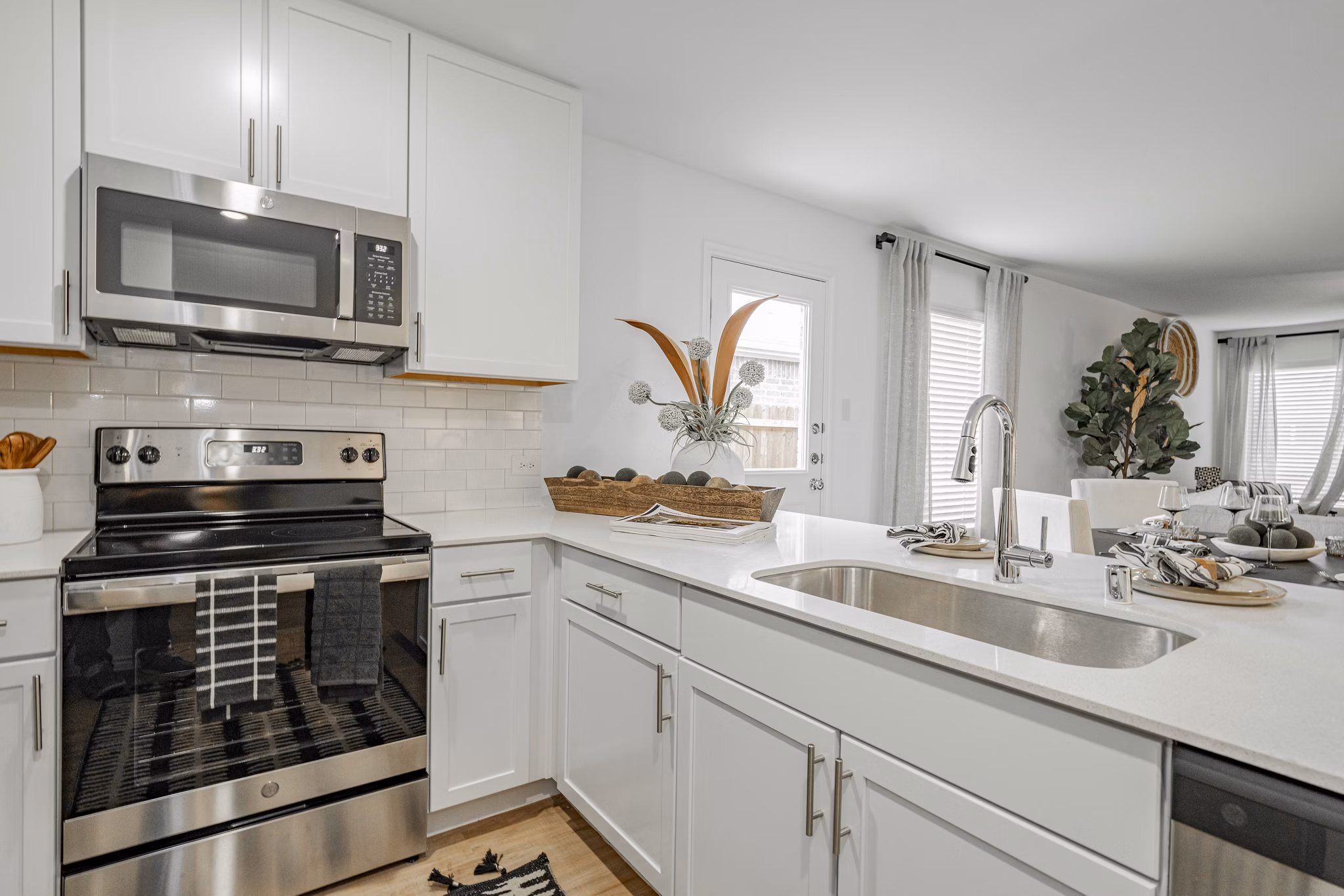 Summerwell Wildcat Ranch Home Apartments: Modern kitchen with stainless steel appliances and island counter