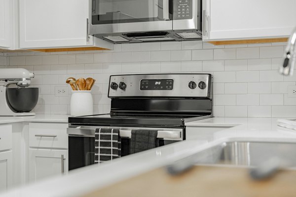Modern kitchen with stainless steel appliances at Summerwell Wildcat Ranch Home Apartments