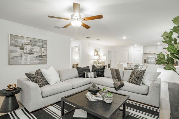Spacious living room with elegant decor at Summerwell Wildcat Ranch Home Apartments