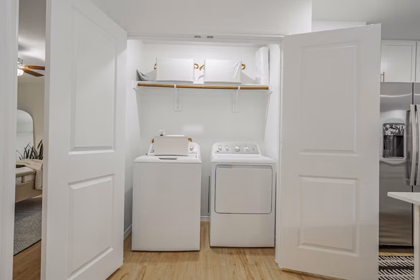Laundry room with modern appliances at Summerwell Wildcat Ranch Apartments, offering convenient in-unit facilities for residents