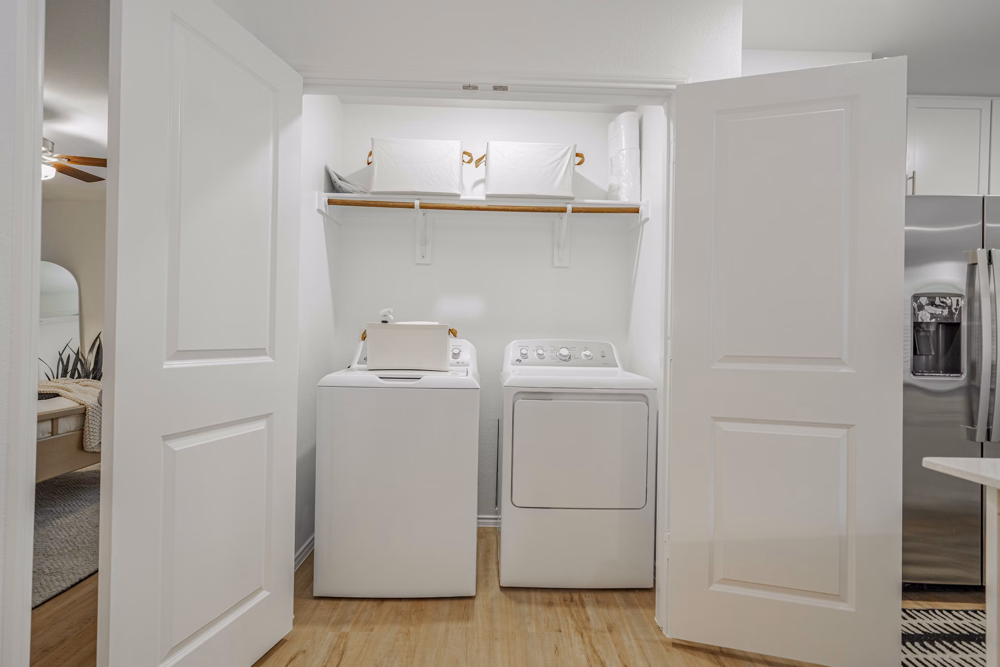 Laundry room with modern appliances at Summerwell Wildcat Ranch Apartments, offering convenient in-unit facilities for residents