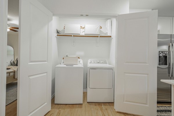 Laundry room with modern appliances at Summerwell Wildcat Ranch Apartments, offering convenient in-unit facilities for residents