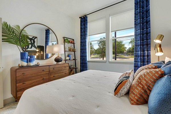Bedroom featuring modern dÃ©cor and ample natural light at Stadia Med Main Apartments
