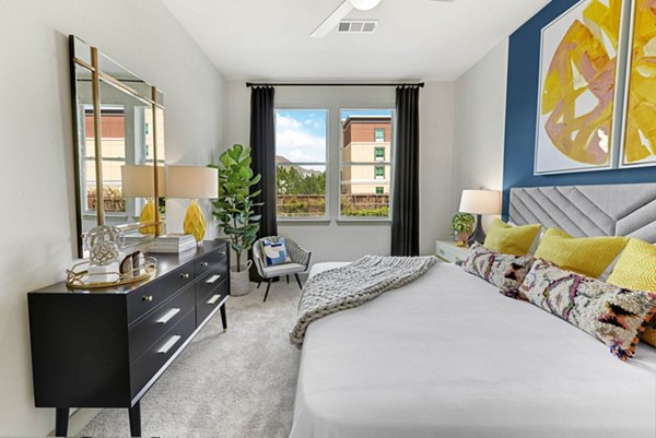 Cozy bedroom with modern decor at Stadia Med Main Apartments featuring stylish furnishings and ample natural light