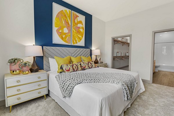 Cozy bedroom with modern decor and large windows at Stadia Med Main Apartments