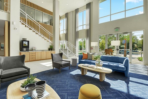 Elegant clubhouse with modern furnishings at Stadia Med Main Apartments featuring luxury amenities for social gatherings