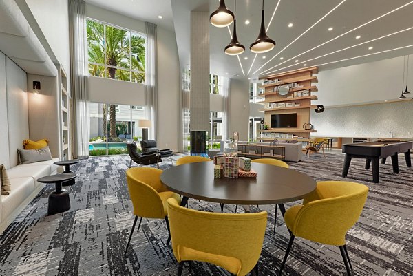 Clubhouse featuring modern design and cozy seating areas at Stadia Med Main Apartments