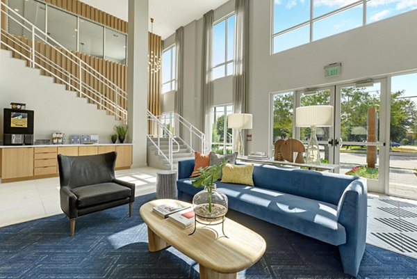 Clubhouse featuring modern design and seating areas at Stadia Med Main Apartments