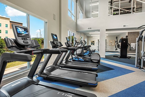 Fitness center with modern equipment at Stadia Med Main Apartments for active living