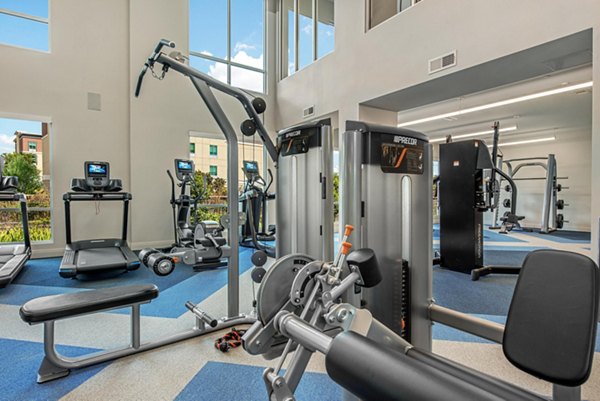 State-of-the-art fitness center at Stadia Med Main Apartments featuring modern equipment and workout spaces