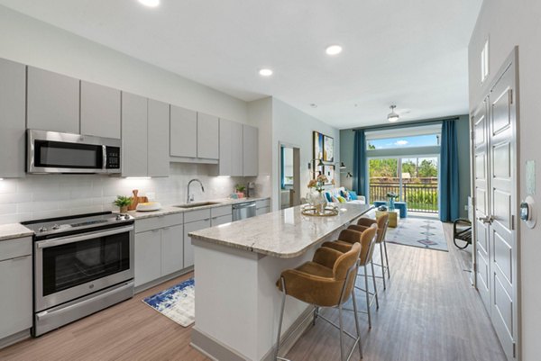 Modern kitchen with stainless steel appliances at Stadia Med Main Apartments