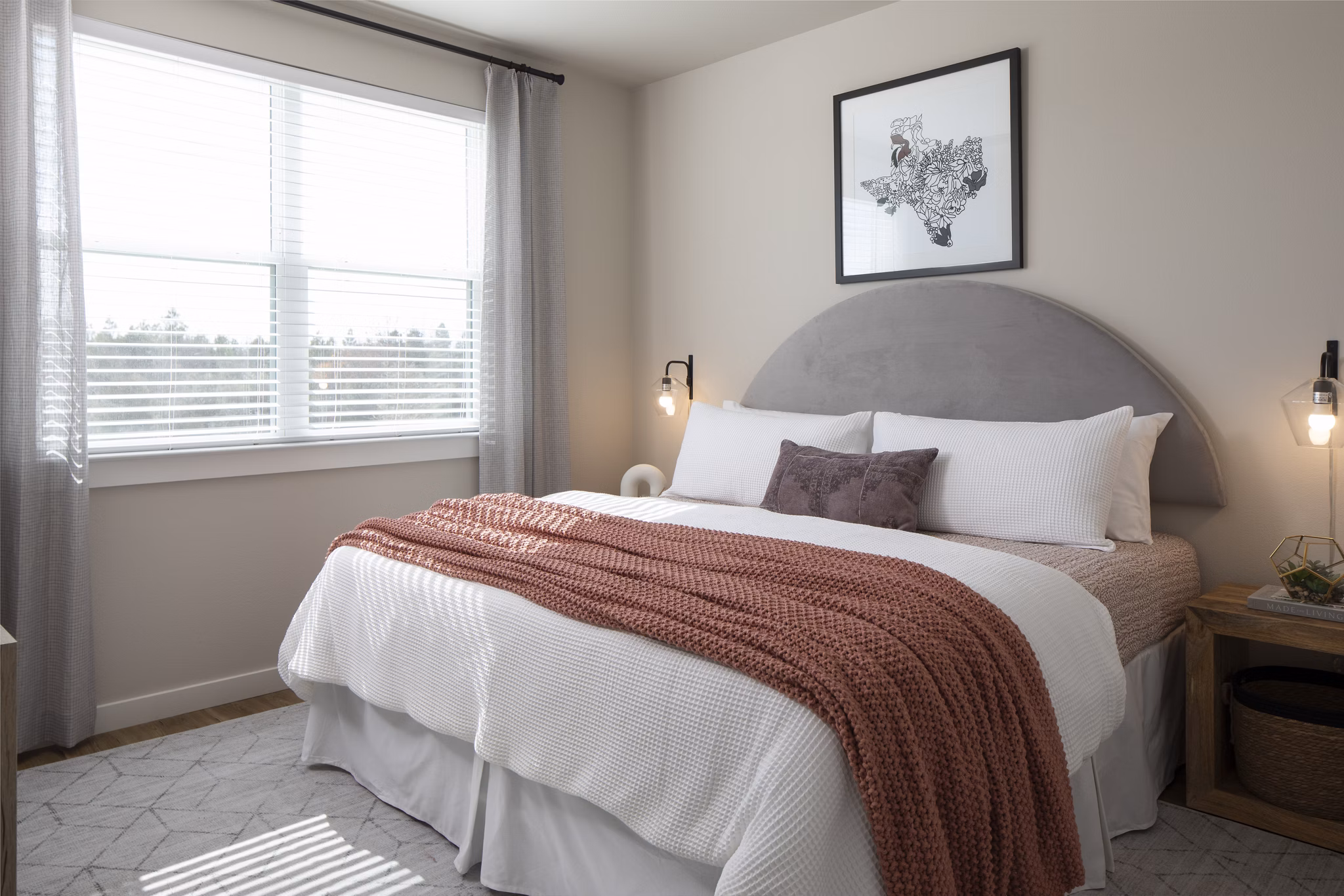 Bedroom featuring stylish decor and cozy bedding at Prose KTX Apartments, a Greystar luxury apartment community in a prime location