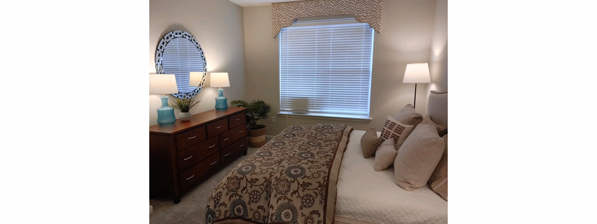 Cozy bedroom featuring modern decor and large windows in Nav850 Apartments