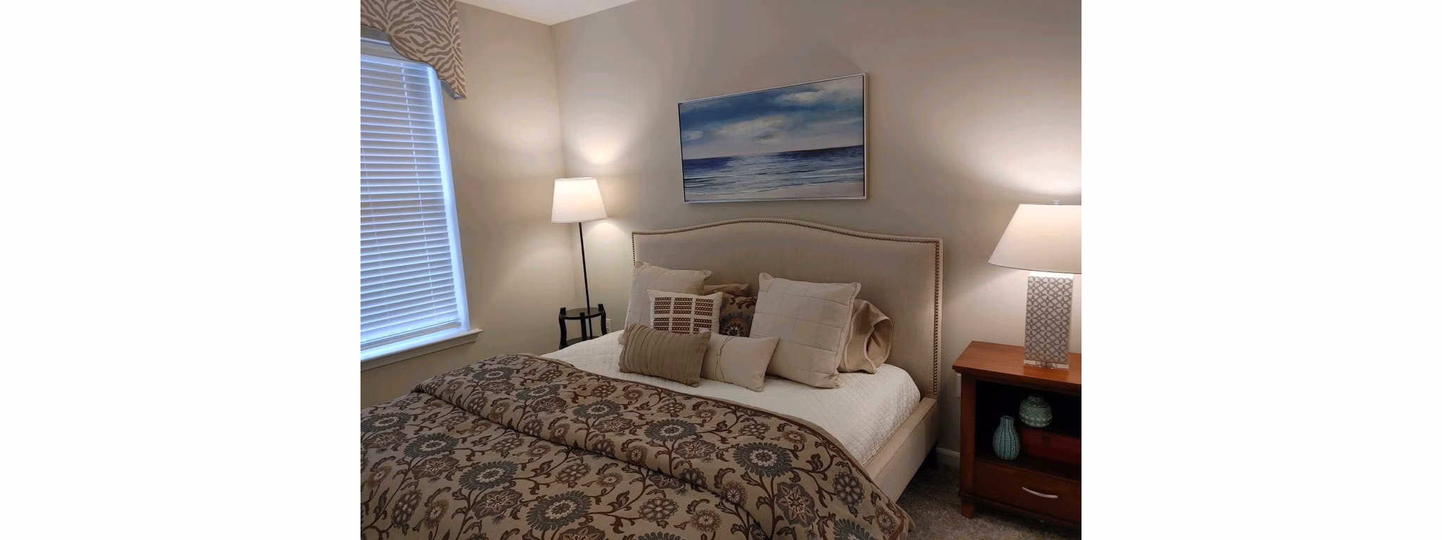 Bedroom with modern decor and large windows at Nav850 Apartments