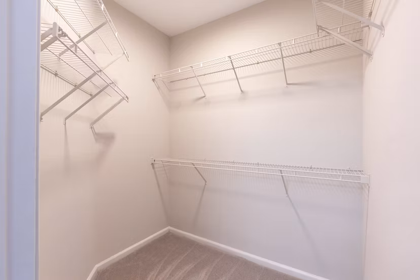 Spacious closet with organized shelving in Nav850 Apartments, perfect for storage needs
