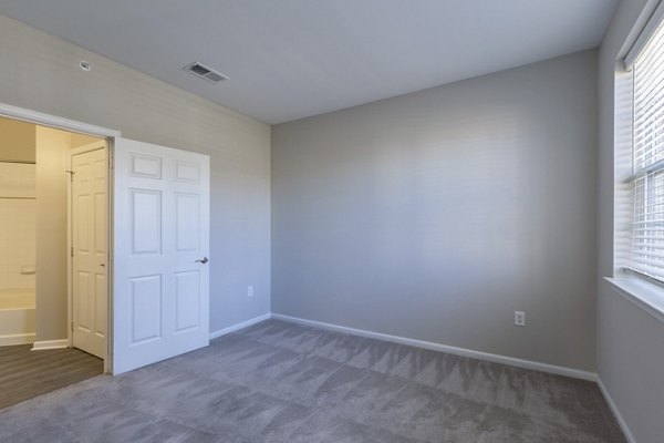 Elegant bedroom featuring modern decor and ample natural light at Nav850 Apartments