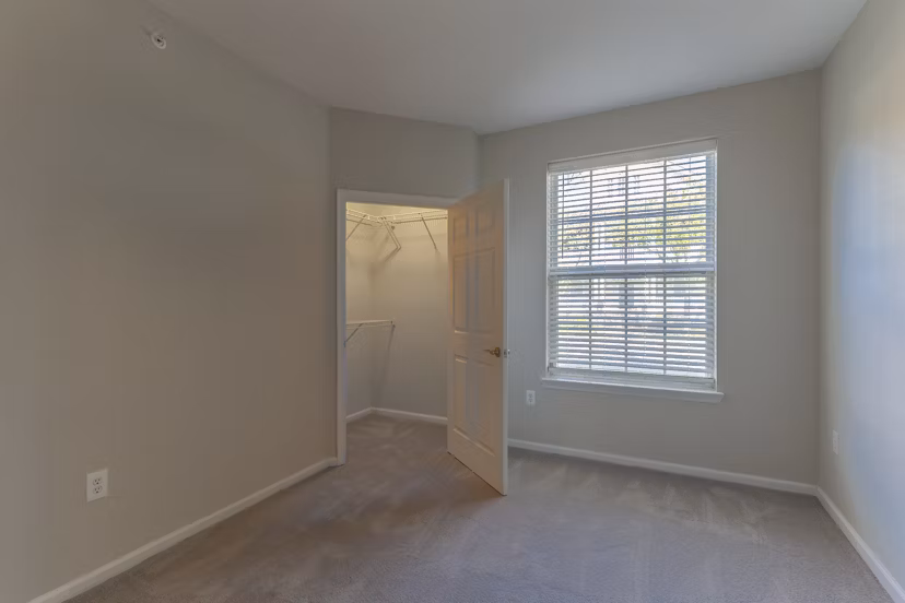 Cozy bedroom with modern decor at Nav850 Apartments featuring ample natural light and stylish furnishings in a luxury setting