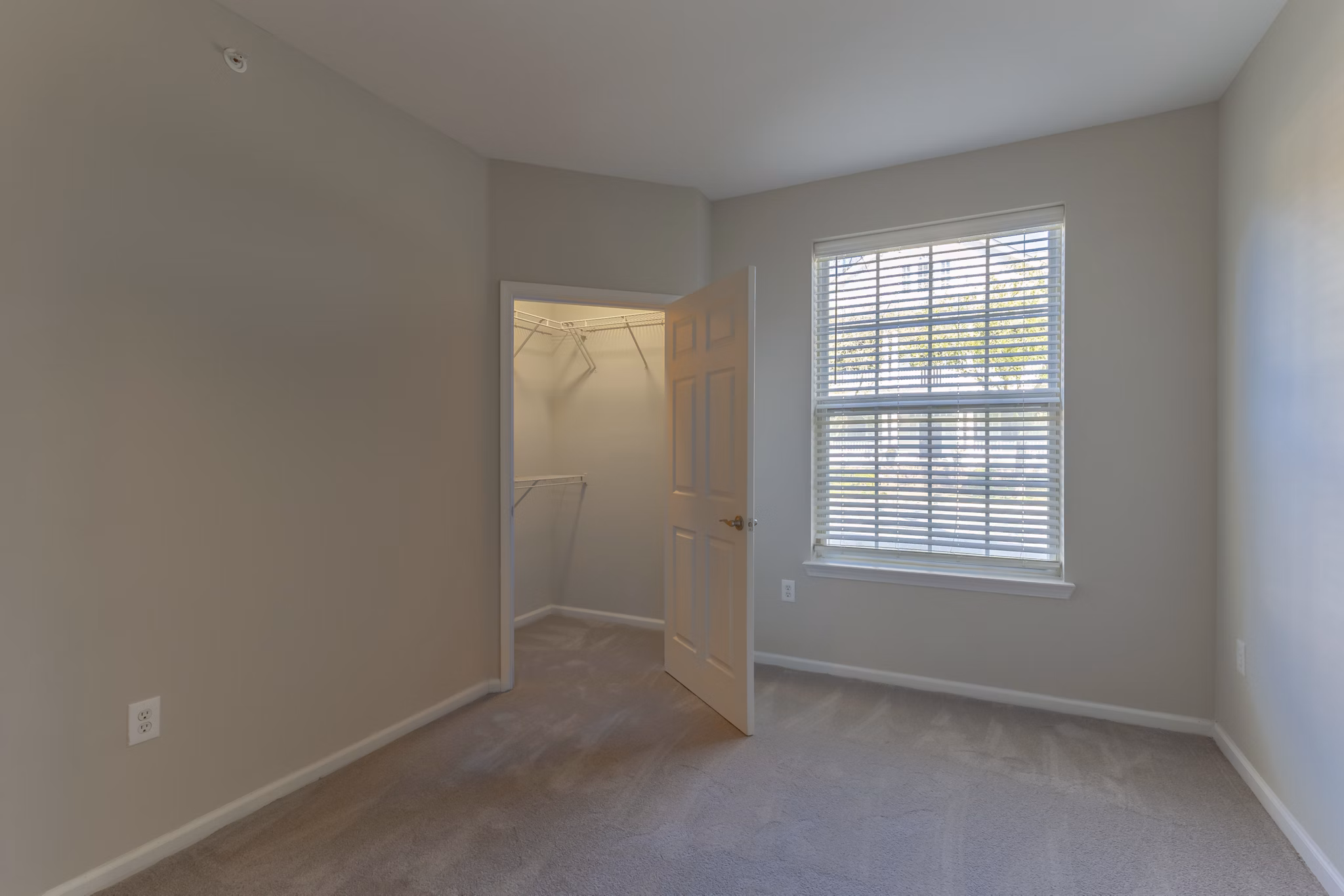 Cozy bedroom with modern decor at Nav850 Apartments featuring ample natural light and stylish furnishings in a luxury setting