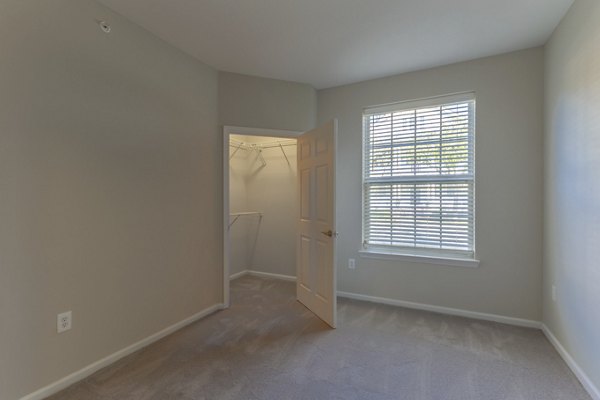 Cozy bedroom with modern decor at Nav850 Apartments featuring ample natural light and stylish furnishings in a luxury setting